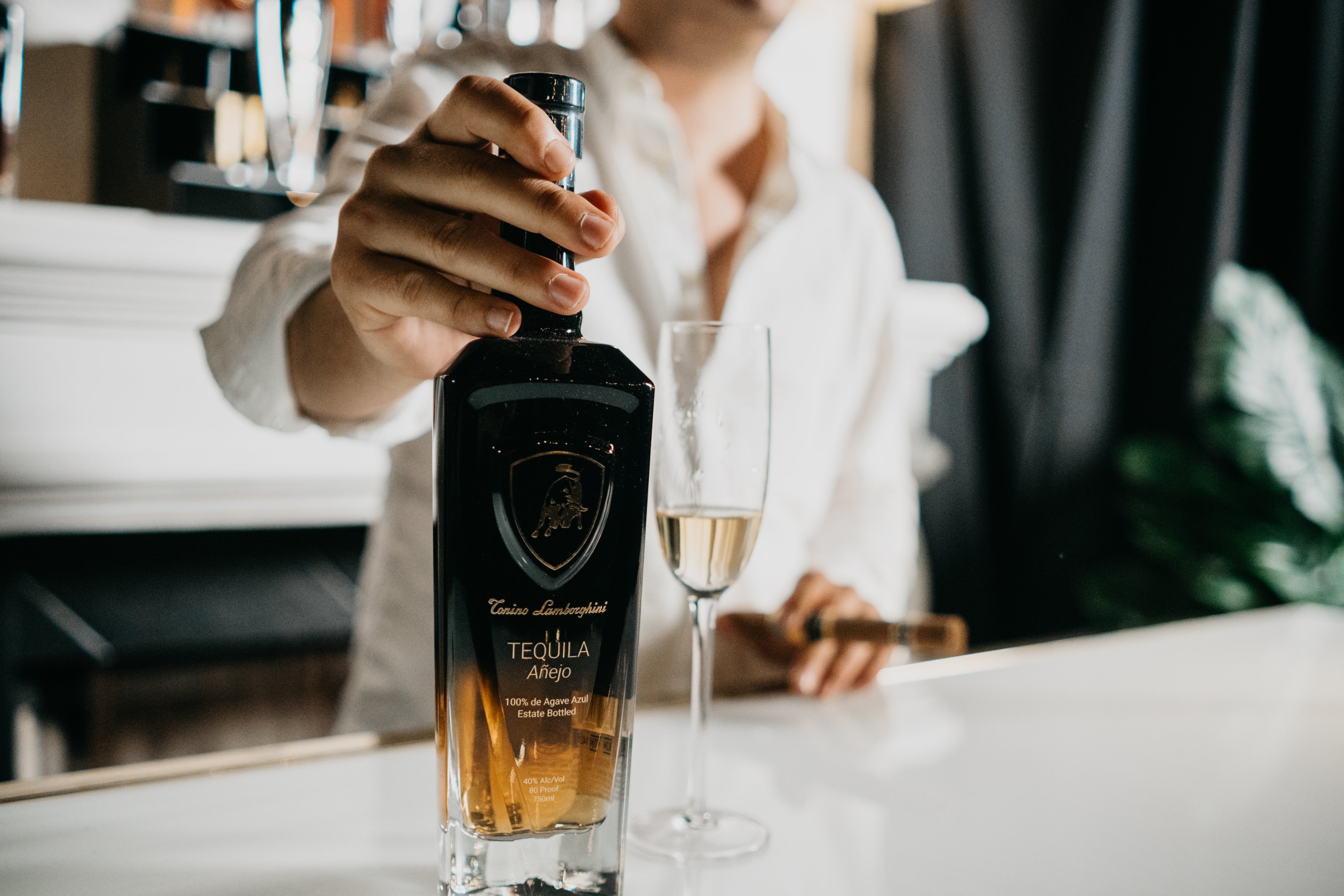 Tonino Lamborghini branded spirit bottle at a bar, official brand photography