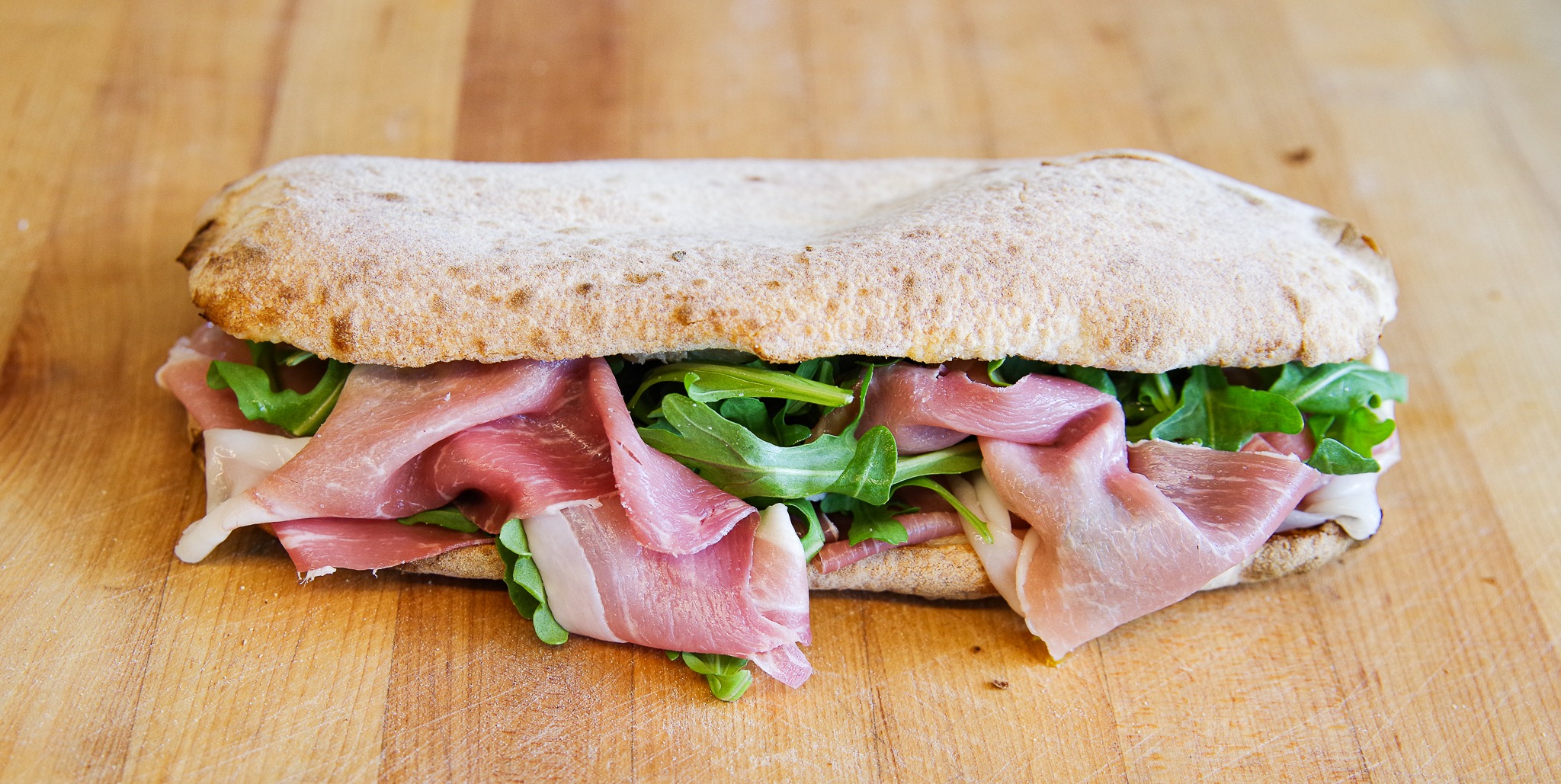 Prosciutto panuozzo with cheese and arugula — supplied photograph