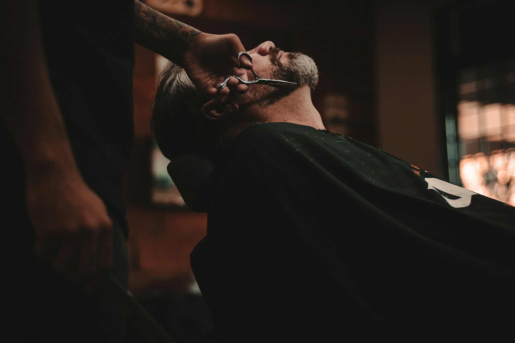 A barber at work inside a neighbourhood barbershop